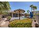 Inviting pool area with lush landscaping, palm trees, covered seating, and inviting ambiance at 8209 Chapelle Ct, Las Vegas, NV 89131