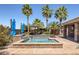 Beautiful backyard pool and spa with lush tropical landscaping offers a relaxing retreat at 8209 Chapelle Ct, Las Vegas, NV 89131