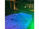 Swimming pool at night with multicolor LED lighting and desert landscaping offering a relaxing backyard ambiance at 8209 Chapelle Ct, Las Vegas, NV 89131