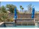 Close-up of backyard pool showcasing its serene water feature and patio umbrella at 8209 Chapelle Ct, Las Vegas, NV 89131