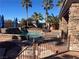 Inviting pool area with palm trees and outdoor seating, perfect for relaxing and entertaining at 8209 Chapelle Ct, Las Vegas, NV 89131