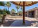 Stunning backyard pool area with palm trees, covered patio and stylish landscaping at 8209 Chapelle Ct, Las Vegas, NV 89131
