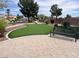 Relax and practice your short game on this charming putting green, surrounded by mature trees and manicured landscaping at 8209 Chapelle Ct, Las Vegas, NV 89131