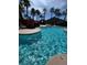 Inviting community pool featuring a rock waterfall and lush palm trees, perfect for outdoor recreation at 8250 N Grand Canyon Dr # 1121, Las Vegas, NV 89166