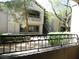 Exterior view of a condominium building with a balcony and manicured landscaping at 8250 N Grand Canyon Dr # 1121, Las Vegas, NV 89166