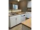 Bright kitchen featuring white appliances, countertop and cabinetry, and a view of the laundry area at 8250 N Grand Canyon Dr # 1121, Las Vegas, NV 89166