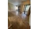 A large living room area featuring tile floors, built-in shelves and access to a balcony at 8250 N Grand Canyon Dr # 1121, Las Vegas, NV 89166