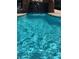 Rock waterfall feature leading into clear, inviting pool waters at 8250 N Grand Canyon Dr # 1121, Las Vegas, NV 89166
