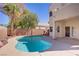 The backyard features a private pool, covered patio, desert landscaping, and a perimeter fence and wall at 830 Binbrook Dr, Henderson, NV 89052