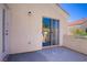 This balcony features stucco walls, a metal railing, and a sliding glass door leading inside the home at 830 Binbrook Dr, Henderson, NV 89052
