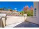 Balcony overlooking a landscaped hill and neighborhood featuring stucco walls, a metal railing, and a concrete flooring at 830 Binbrook Dr, Henderson, NV 89052
