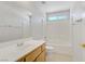 Bathroom with a vanity, toilet, and shower-tub combo, all in a clean, white finish at 830 Binbrook Dr, Henderson, NV 89052