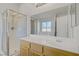 Bright bathroom features a shower, vanity, and mirror at 830 Binbrook Dr, Henderson, NV 89052