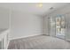 Bonus room features neutral carpet and access to a private outdoor patio at 830 Binbrook Dr, Henderson, NV 89052