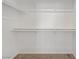 A simple walk-in closet with white walls, shelving, and carpeted floor at 830 Binbrook Dr, Henderson, NV 89052