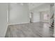 Spacious living room with wood floors, a stairway, and an adjacent dining room featuring a chandelier at 830 Binbrook Dr, Henderson, NV 89052