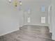 Living room with wood floors, featuring a chandelier, stairs, and neutral paint and lots of natural light at 830 Binbrook Dr, Henderson, NV 89052
