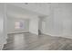 Bright living room with wood floors, featuring a chandelier, stairs, and neutral paint at 830 Binbrook Dr, Henderson, NV 89052
