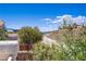 This beautiful view features desert hills, greenery, blue skies, and the city in the distance from the balcony at 830 Binbrook Dr, Henderson, NV 89052