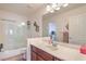 Bathroom with a single sink vanity and a shower-tub combo with a glass enclosure at 8454 Mondavi Hill Ct, Las Vegas, NV 89139