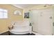 Bright bathroom featuring a soaking tub and walk-in shower with glass door and black tile flooring at 8454 Mondavi Hill Ct, Las Vegas, NV 89139