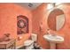 A half bathroom showcasing textured walls, a pedestal sink and unique decor, located on the main level at 8454 Mondavi Hill Ct, Las Vegas, NV 89139