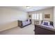 Bright bedroom featuring twin beds, a window with shutters, and neutral-toned carpet at 8454 Mondavi Hill Ct, Las Vegas, NV 89139