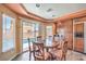 Bright breakfast nook with a round table, pool view, and ample natural light at 8454 Mondavi Hill Ct, Las Vegas, NV 89139
