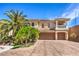 Beautiful two-story home with a dual garage, balcony, and mature landscaping at 8454 Mondavi Hill Ct, Las Vegas, NV 89139