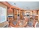 A kitchen and breakfast nook showcasing rich wood cabinetry and granite countertops, with stone tiled floors at 8454 Mondavi Hill Ct, Las Vegas, NV 89139