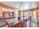 A kitchen area with a large island featuring granite countertops, perfect for food prep and entertaining guests at 8454 Mondavi Hill Ct, Las Vegas, NV 89139