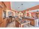 A spacious kitchen features wood cabinets, granite counters, stainless appliances and a center island for cooking at 8454 Mondavi Hill Ct, Las Vegas, NV 89139