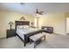 A primary bedroom with plantation shutters, carpeted floors and a cozy seating area with a sofa and bench at 8454 Mondavi Hill Ct, Las Vegas, NV 89139