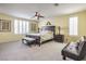 A primary bedroom with plush carpeting, a ceiling fan and windows covered by plantation shutters for privacy at 8454 Mondavi Hill Ct, Las Vegas, NV 89139