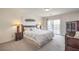 Spacious main bedroom featuring a king-size bed, a private balcony, and traditional furnishings at 8454 Mondavi Hill Ct, Las Vegas, NV 89139