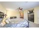 A spacious primary bedroom with a ceiling fan, plush carpeting and a view into the attached ensuite bathroom at 8454 Mondavi Hill Ct, Las Vegas, NV 89139