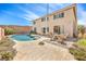 Backyard with inground pool, patio, table, and chairs creates an inviting outdoor space for enjoyment at 8454 Mondavi Hill Ct, Las Vegas, NV 89139