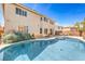 Lush backyard showcasing a sparkling pool, complemented by mature landscaping and a well-maintained lawn at 8454 Mondavi Hill Ct, Las Vegas, NV 89139