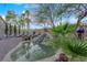 Lush backyard with waterfall feature and tropical landscaping offers a serene escape at 8824 Prague Ct, Las Vegas, NV 89147