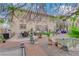 Backyard featuring outdoor kitchen, dining area, mature landscaping, and water feature at 8824 Prague Ct, Las Vegas, NV 89147