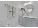 Well-lit bathroom with elegant vanity, marble walls and glass-enclosed shower at 8824 Prague Ct, Las Vegas, NV 89147
