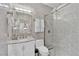 Contemporary bathroom with marble walls and glass-enclosed shower at 8824 Prague Ct, Las Vegas, NV 89147