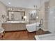 Elegant bathroom with a soaking tub, glass shower, and double vanity at 8824 Prague Ct, Las Vegas, NV 89147