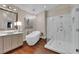 Luxurious bathroom features soaking tub, glass shower, and chandelier at 8824 Prague Ct, Las Vegas, NV 89147