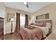 Well-lit bedroom with hardwood floors, a cozy bed, and large windows at 8824 Prague Ct, Las Vegas, NV 89147