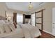 Bedroom features a comfortable bed, window, and sliding barn door to bathroom at 8824 Prague Ct, Las Vegas, NV 89147
