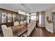 Open-concept dining room featuring a large wood table, chandelier lighting and comfortable chairs at 8824 Prague Ct, Las Vegas, NV 89147
