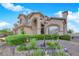 Lovely beige two-story home with manicured bushes and mature landscaping in a desert setting at 8824 Prague Ct, Las Vegas, NV 89147