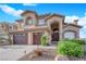 Stunning two-story home with three-car garage, desert landscaping and covered front entry at 8824 Prague Ct, Las Vegas, NV 89147