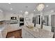 Well-appointed kitchen boasts stainless steel appliances, a center island, and elegant chandeliers at 8824 Prague Ct, Las Vegas, NV 89147